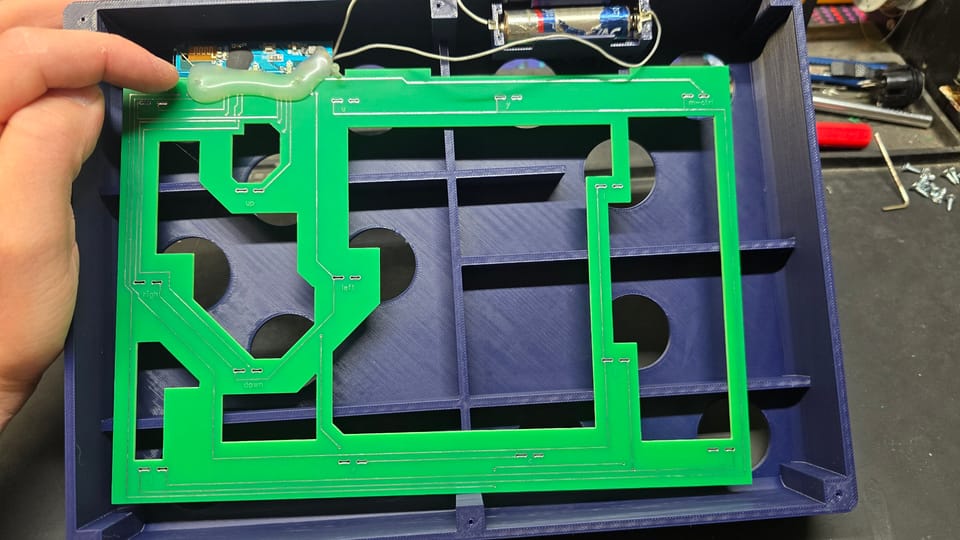 The board set into the 3D-printed case with the AA battery holder