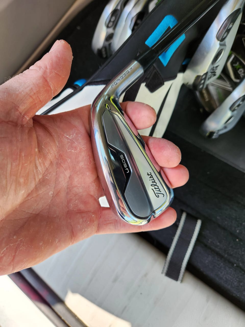 An iron head held up close after cleaning, grooves sharp